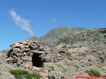 El chozo con El Peñotillo y La Maliciosa asomando al fondo.